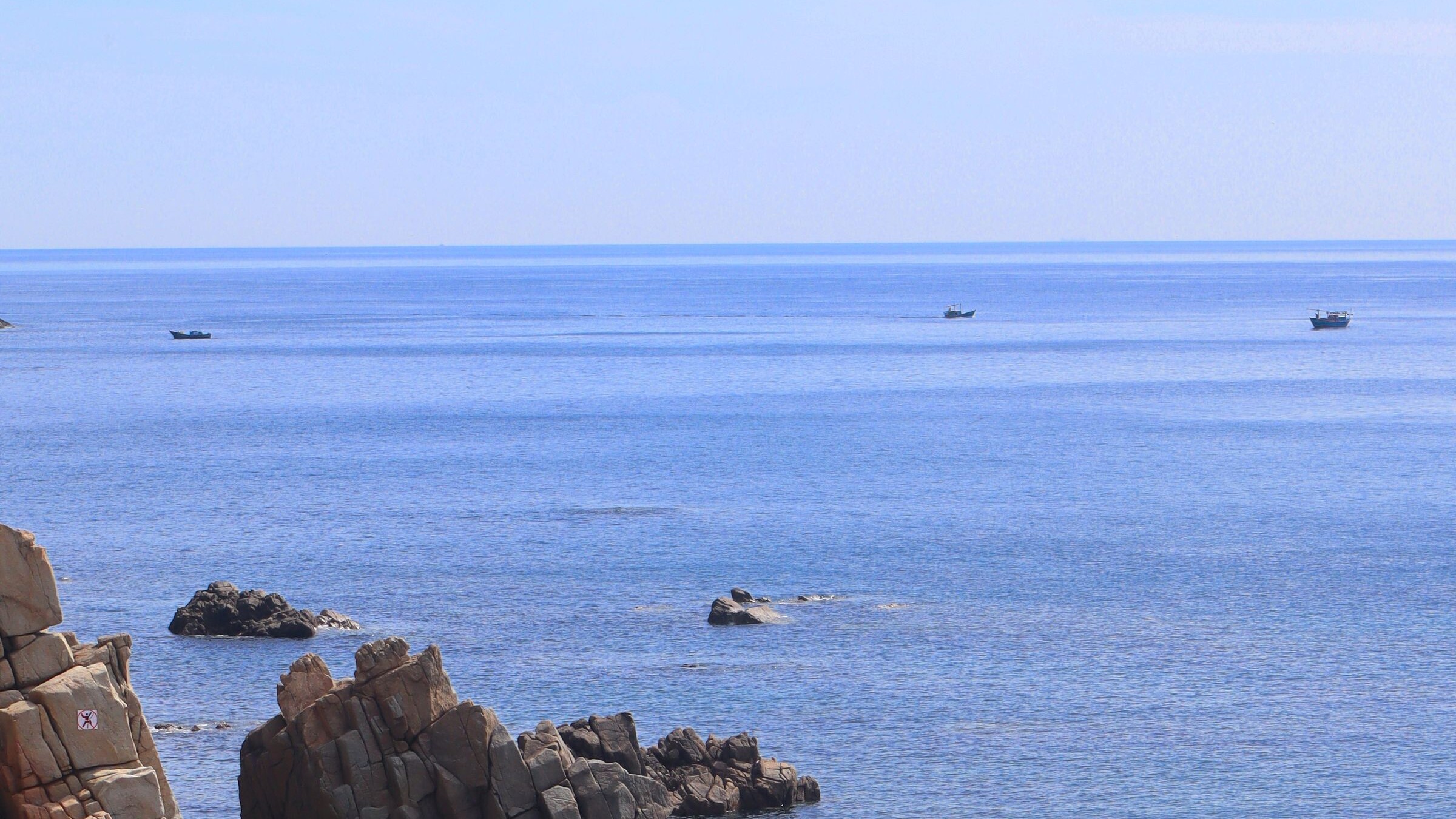 Rocky coastline and calm blue sea in Quy Nhon, Vietnam
