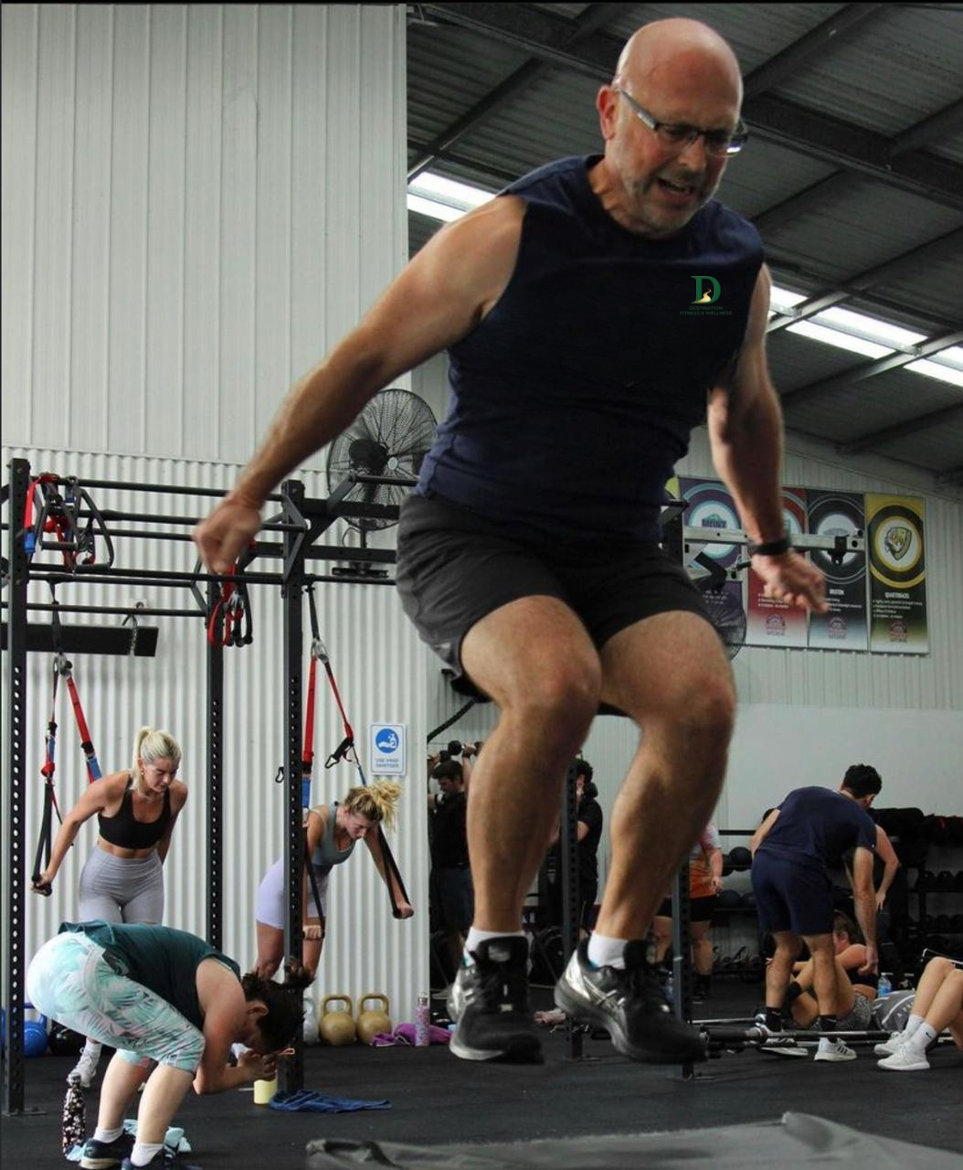 Destination Fitness & Wellness trainer completing a dynamic gym exercise